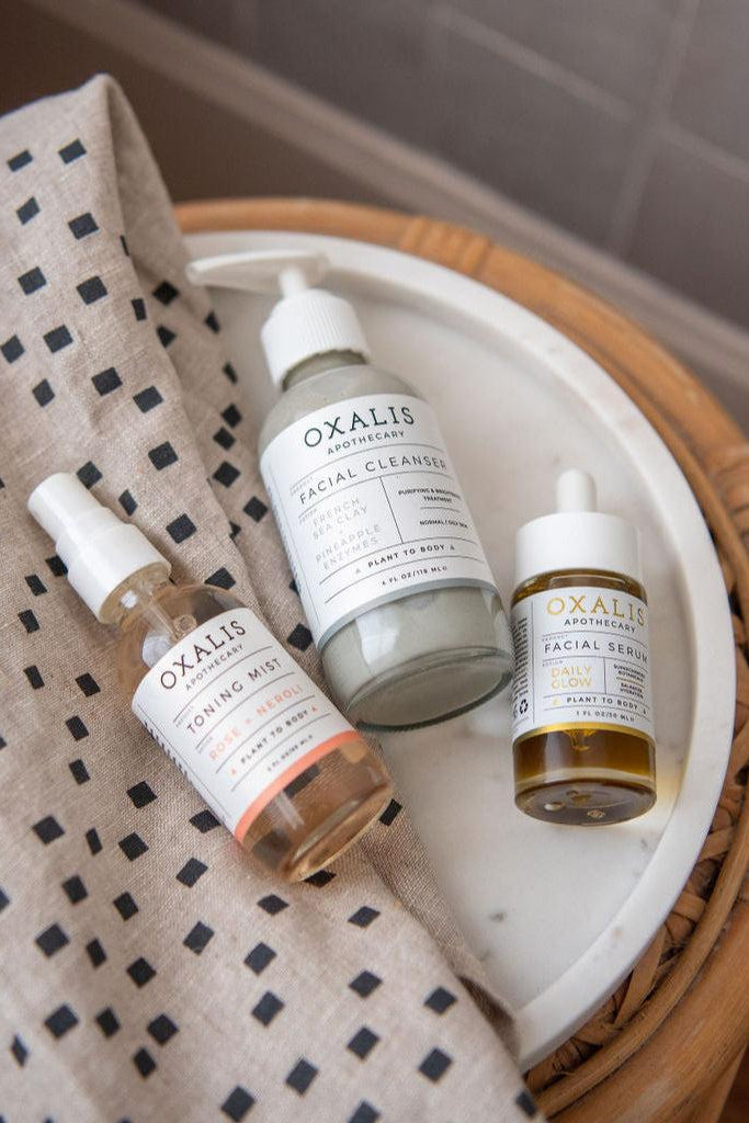 Oxalis Apothecary plant-powered skincare routine featuring Rose Neroli Toning Mist, French Sea Clay Facial Cleanser, and Daily Glow Facial Serum.