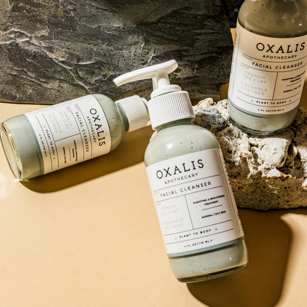 The Oxalis French Sea Clay + Pineapple Enzyme Cleanser. Flat Lay.